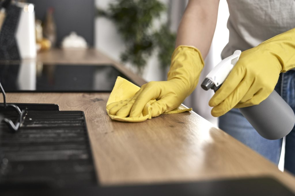 Close up of caucasian woman cleaning kitchen at home