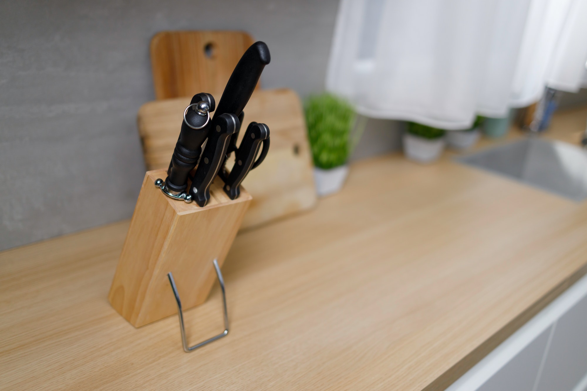Knives in a wooden block on a kitchen countertop