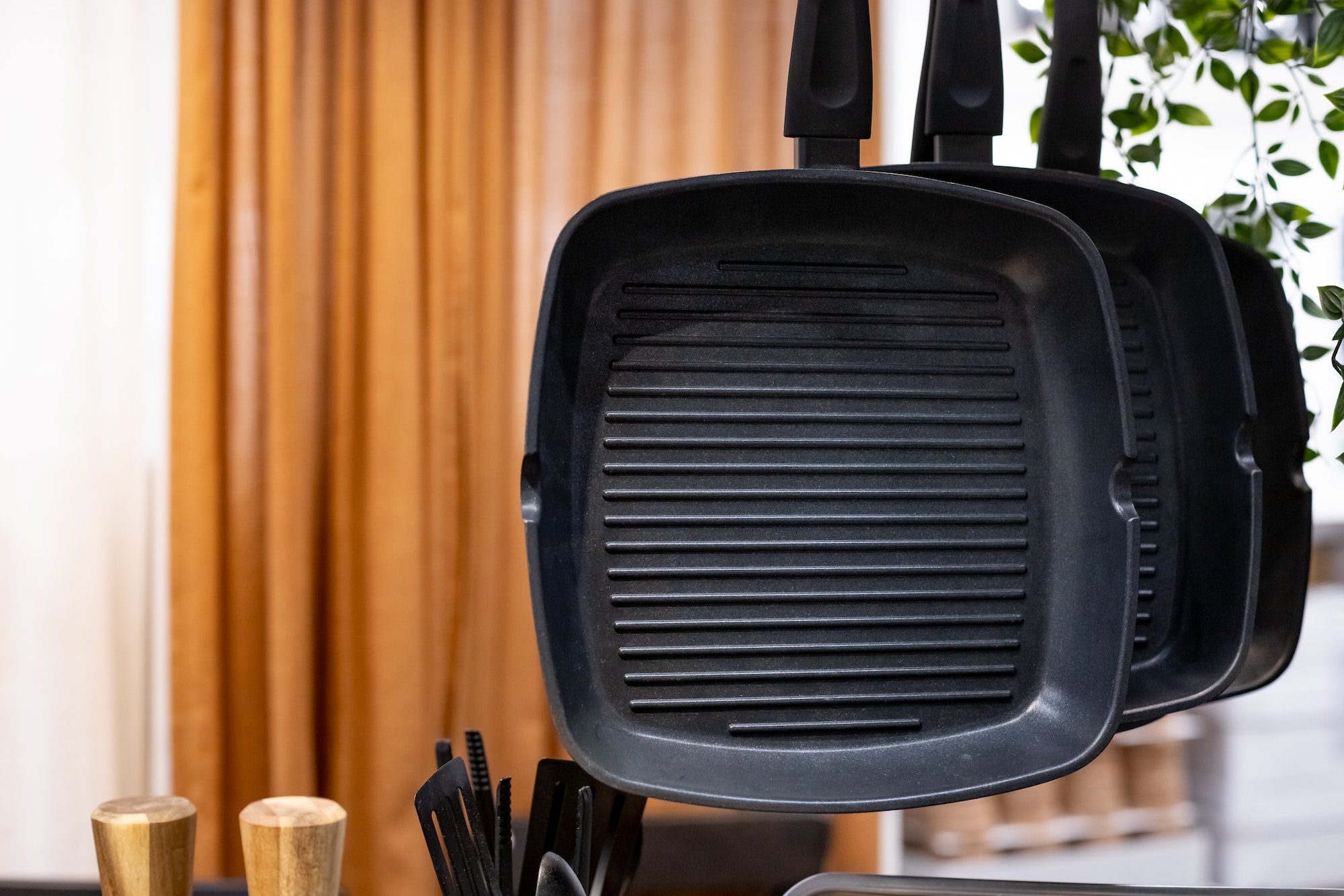 three hanging stainless frying pans for grill. Kitchen utensils.Stainless steel cookware ,