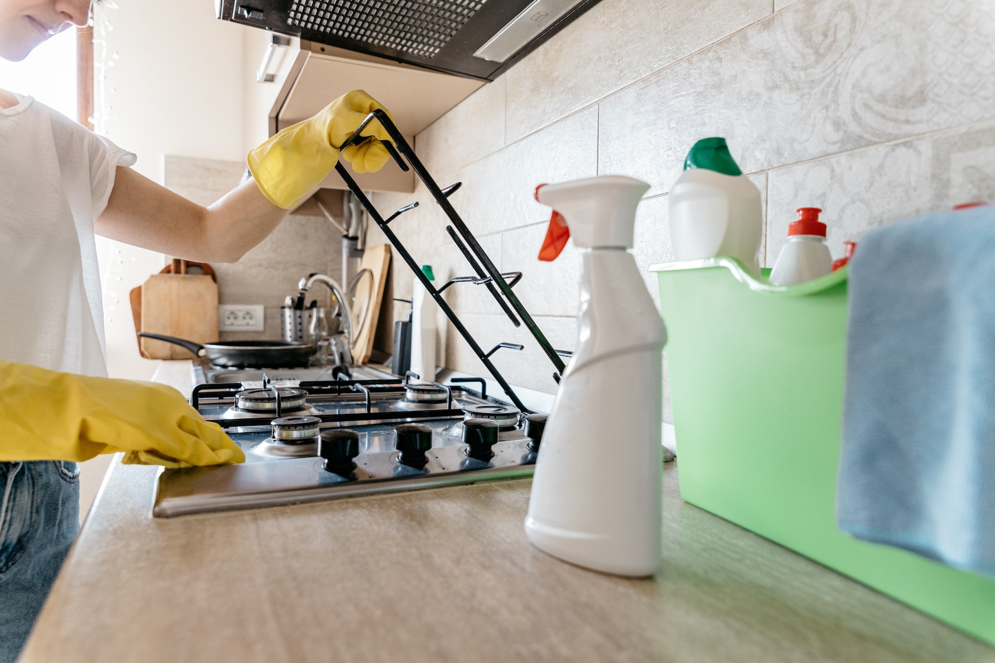 Woman cleaning the kitchen of her apartment.